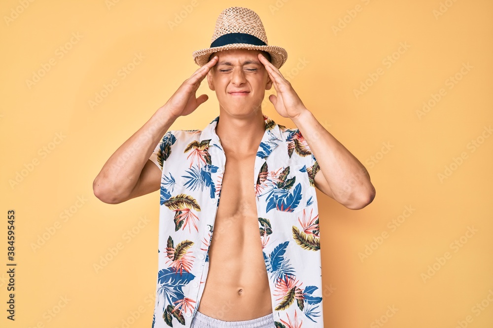 Young hispanic boy wearing summer hat with hand on head, headache because stress. suffering migraine. Young hispanic boy wearing summer hat with hand on head, headache because stress. suffering migraine.