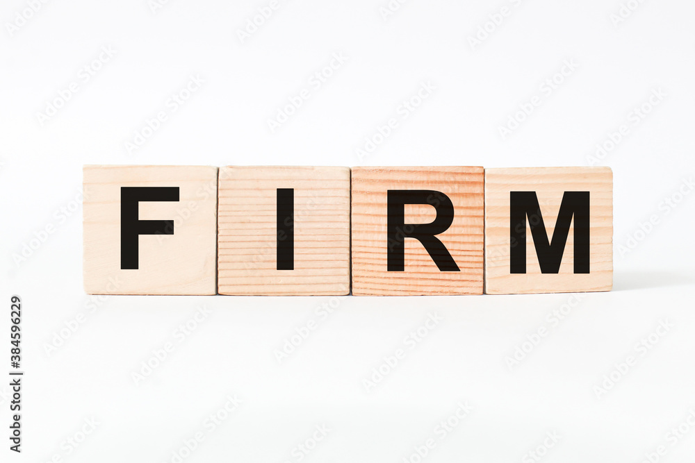 words FIRM on wooden cubes, white background. business concept words FIRM on wooden cubes, white background. business concept