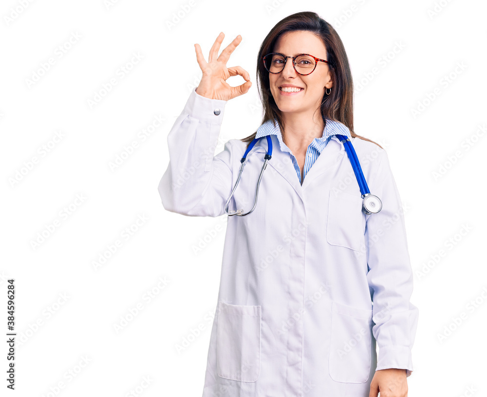 Young beautiful woman wearing doctor stethoscope and glasses smiling positive doing ok sign with hand and fingers. successful expression. Young beautiful woman wearing doctor stethoscope and glasses smiling positive doing ok sign with hand and fingers. successful expression.
