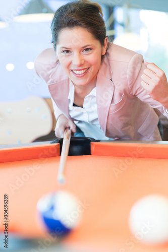 woman aiming for blue pool ball photo