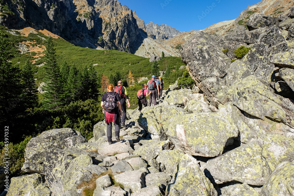 Hikers on trail at Great Cold Valley,  Vysoke Tatry (High Tatras), Slovakia. The Great Cold Valley is 7 km long valley, very attractive for tourists