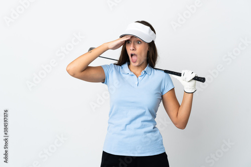 Young golfer woman over isolated white background doing surprise gesture while looking to the side © luismolinero