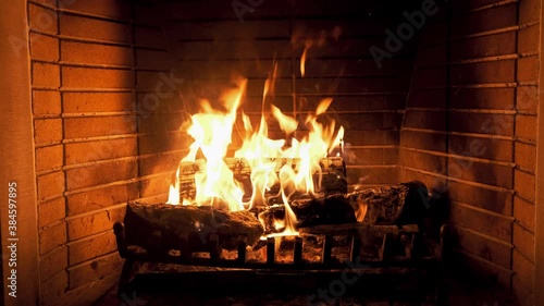 Christmas time. Wood burning in a cozy fireplace at home 4k footage