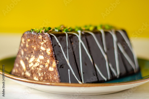 Chocolate mosaic cake on blue porcelain plate