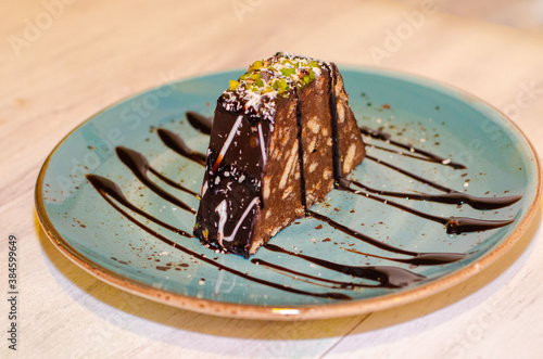 Chocolate mosaic cake on blue porcelain plate