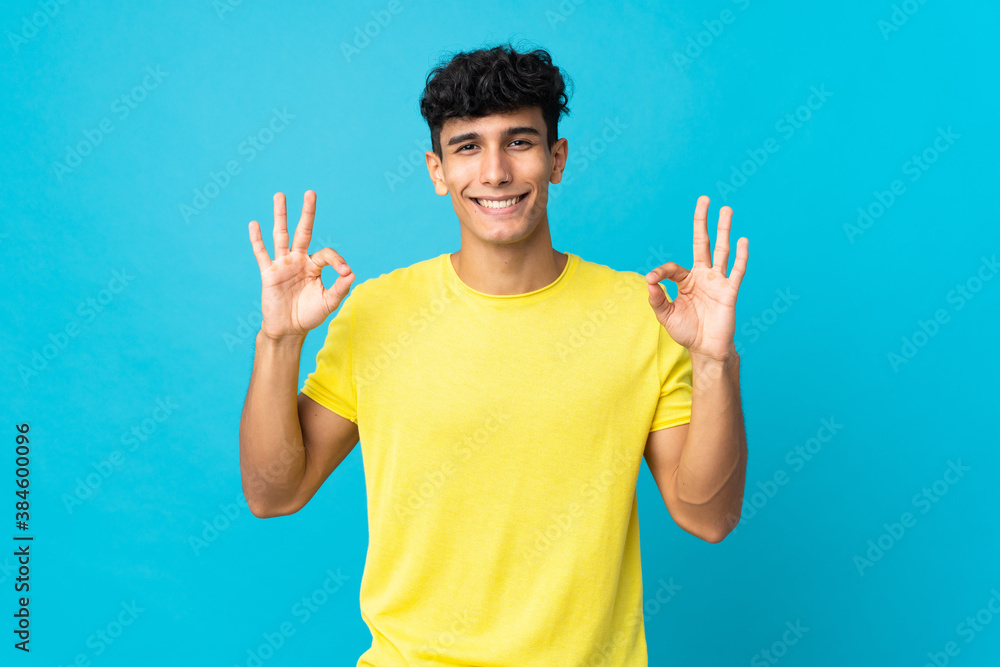 Young Argentinian man isolated on background in zen pose Young Argentinian man isolated on background in zen pose
