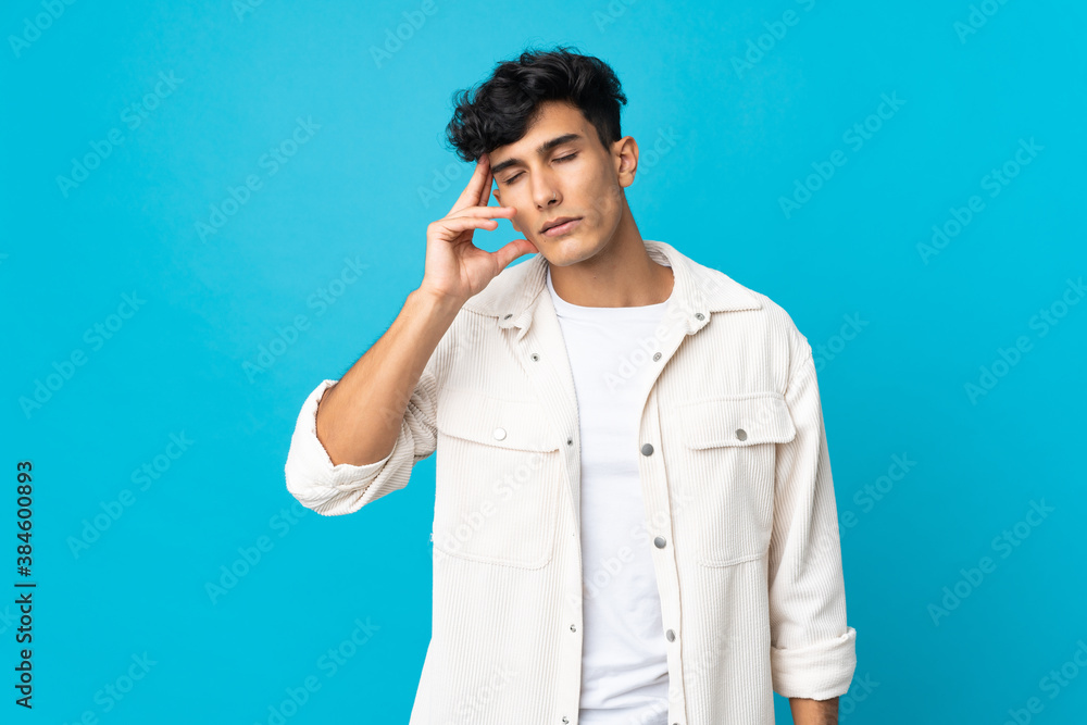 Young Argentinian man isolated on background with headache Young Argentinian man isolated on background with headache