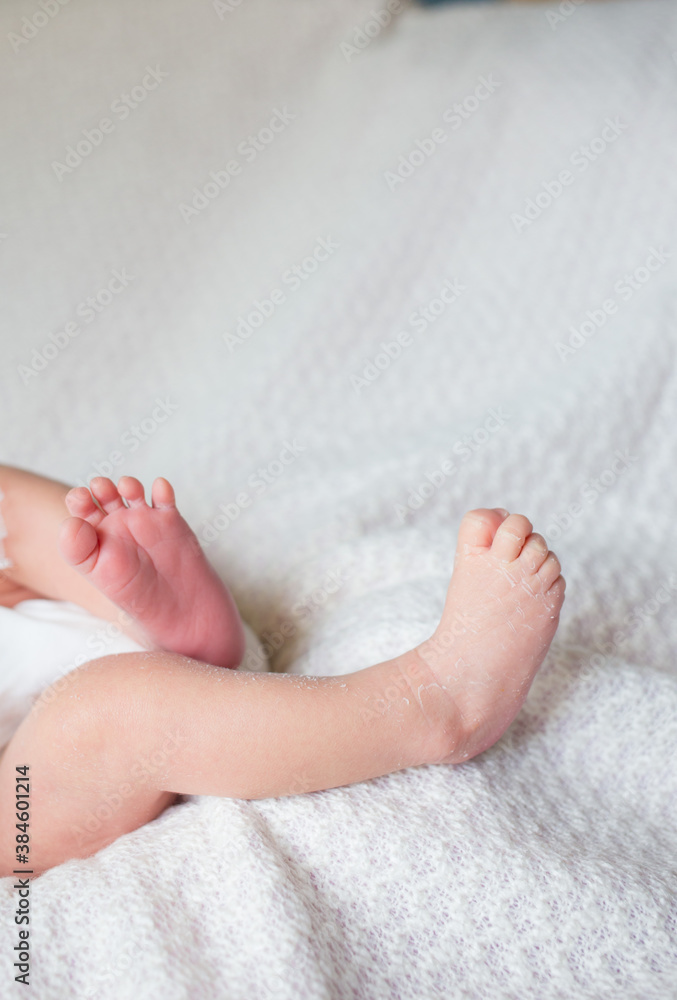 Newborn baby feet on a white blanket. Newborn baby feet on a white blanket.