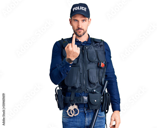 Young handsome man wearing police uniform showing middle finger, impolite and rude fuck off expression
