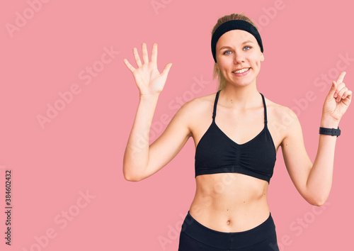 Young beautiful blonde woman wearing sportswear showing and pointing up with fingers number six while smiling confident and happy.