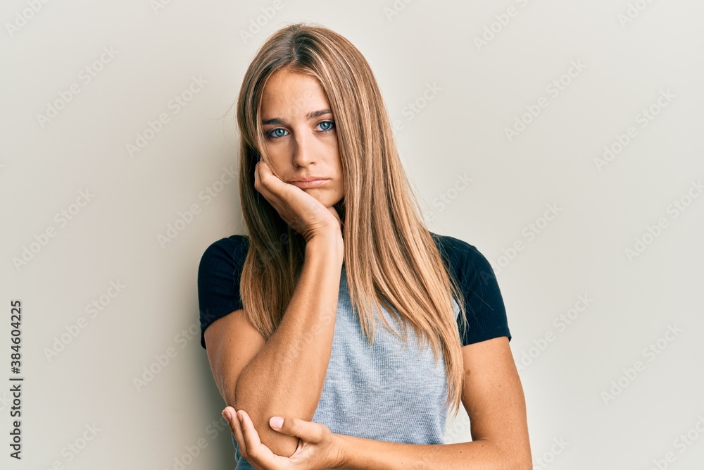 Young blonde woman wearing casual clothes thinking looking tired and bored with depression problems with crossed arms. Young blonde woman wearing casual clothes thinking looking tired and bored with depression problems with crossed arms.