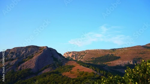 Rare clouds float over Mount Demerdzhi. Summer evening in the mountains of the Crimean Peninsula (Timelapse)