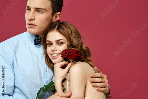 portrait of romantic couple in love with red rose on isolated background and classic suit evening dress