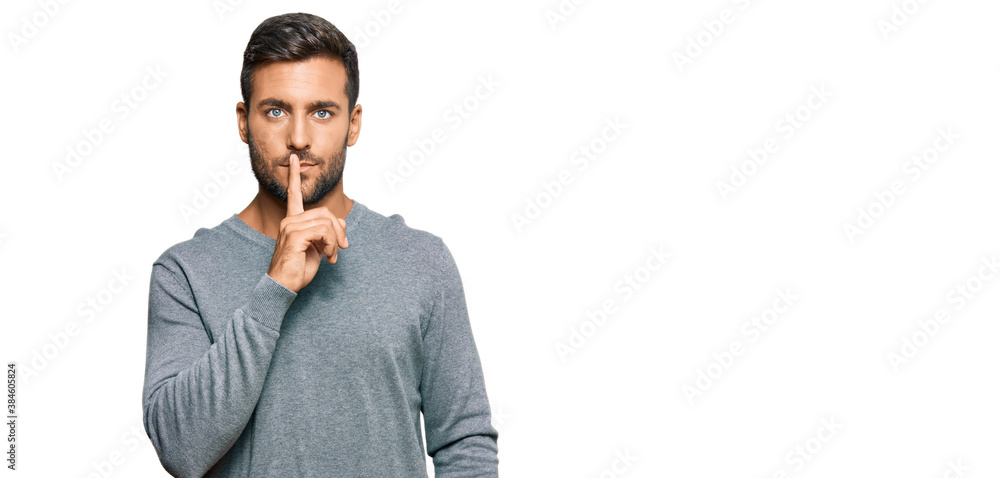 Handsome hispanic man wearing casual clothes asking to be quiet with finger on lips. silence and secret concept. Handsome hispanic man wearing casual clothes asking to be quiet with finger on lips. silence and secret concept.