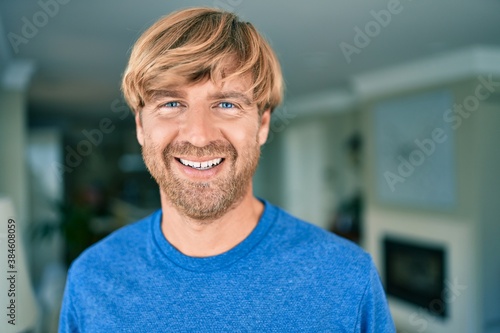 Young irish man smiling happy standing at home