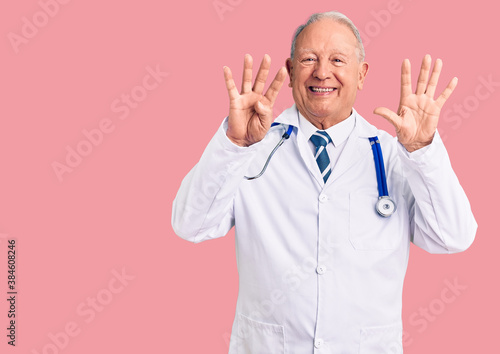 Senior handsome grey-haired man wearing doctor coat and stethoscope showing and pointing up with fingers number nine while smiling confident and happy. © Krakenimages.com
