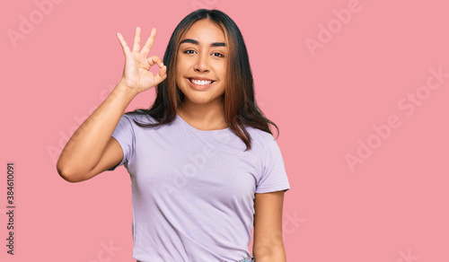 Wallpaper Mural Young latin woman wearing casual clothes smiling positive doing ok sign with hand and fingers. successful expression. Torontodigital.ca