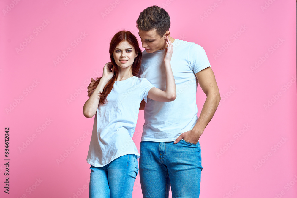 lovers man and woman in jeans and t-shirt on pink background cropped view family romance teenagers lovers man and woman in jeans and t-shirt on pink background cropped view family romance teenagers