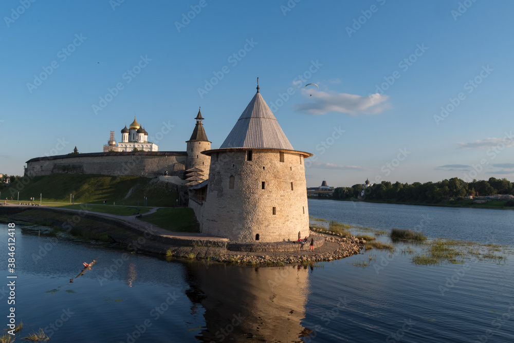 Pskov Kremlin view from river Pskova creek. Towers, wall and Trinity cathedral on background.