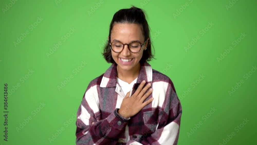 woman keeping the arms crossed while smiling on green screen chroma key background woman keeping the arms crossed while smiling on green screen chroma key background