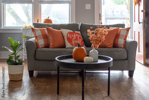 Fototapeta Naklejka Na Ścianę i Meble -  Home interior decorated for fall with orange accent pillows on the couch