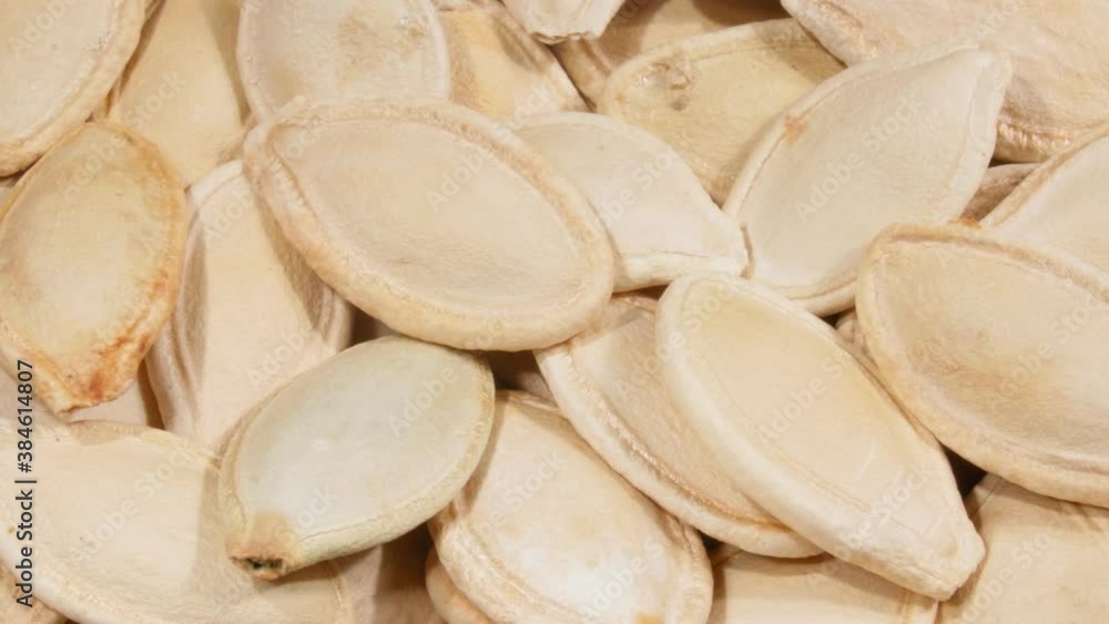 Pumpkin seeds close-up. The seeds in the white peel. Pumpkin seeds close-up. The seeds in the white peel.