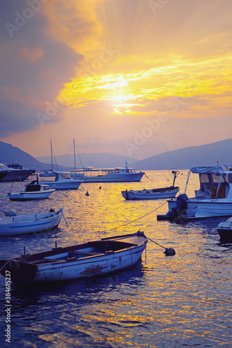 Autumn sunset. Beautiful Mediterranean landscape with boats on water. Montenegro, Kotor Bay