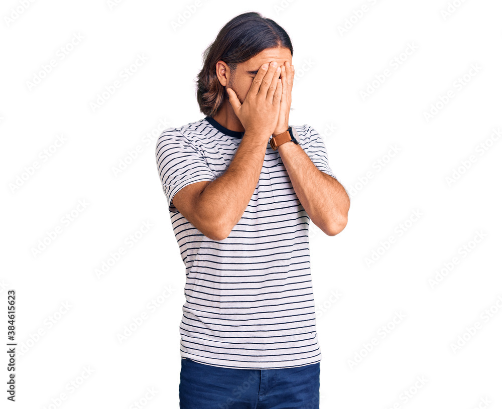 Young handsome man wearing casual clothes with sad expression covering face with hands while crying. depression concept. Young handsome man wearing casual clothes with sad expression covering face with hands while crying. depression concept.