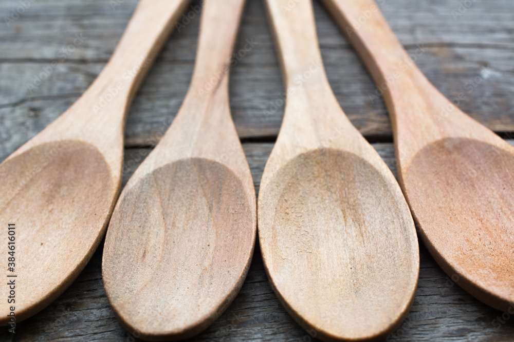 Four empty wooden spoons on a wooden table. Four empty wooden spoons on a wooden table.