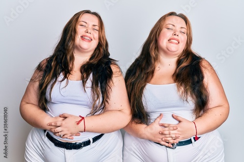 Plus size caucasian sisters woman wearing casual white clothes with hand on stomach because nausea, painful disease feeling unwell. ache concept.