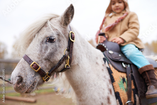 Little Girl Riding Appaloosa Pony