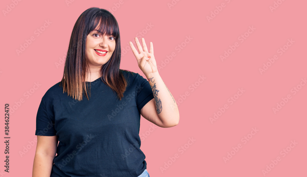 Young plus size woman wearing casual clothes showing and pointing up with fingers number four while smiling confident and happy. Young plus size woman wearing casual clothes showing and pointing up with fingers number four while smiling confident and happy.