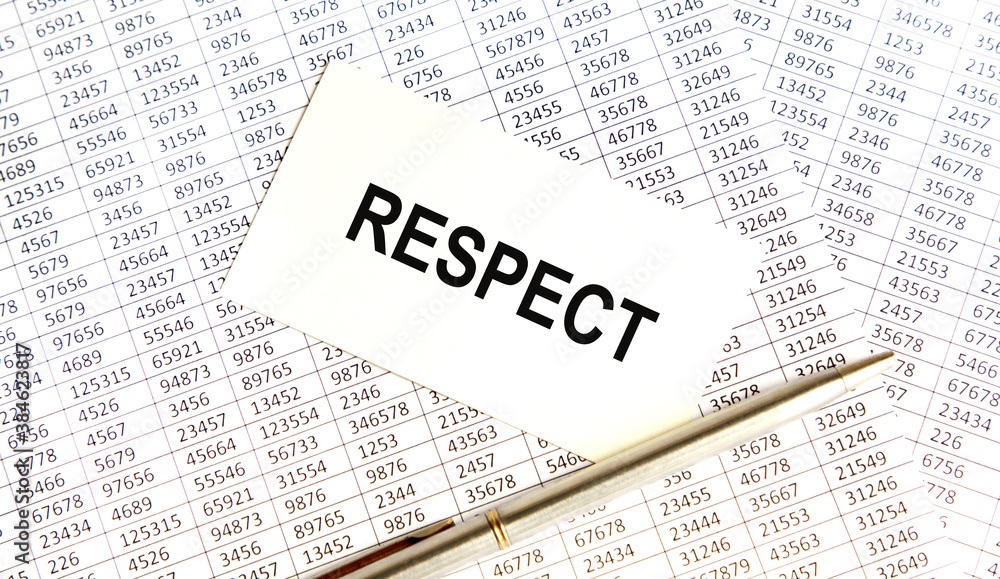 On the business card is the inscription RESPECT, next to the pen. Reports serve as the background. On the business card is the inscription RESPECT, next to the pen. Reports serve as the background.