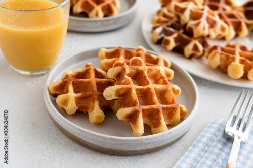 Belgian waffles with glass of orange juice for breakfast