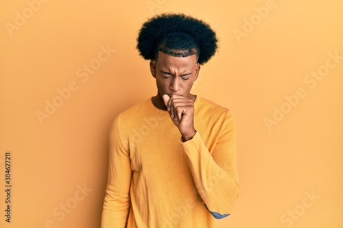 African american man with afro hair wearing casual clothes feeling unwell and coughing as symptom for cold or bronchitis. health care concept.