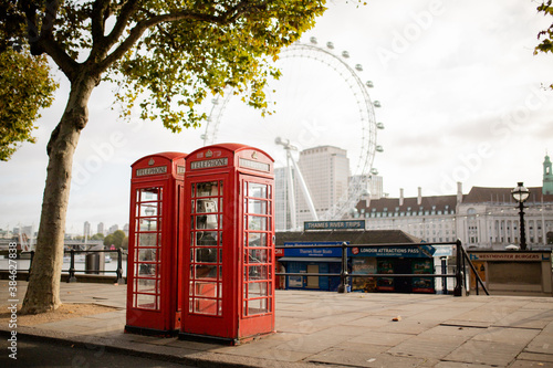 Photography British Telephone Booths Under a Tree and with The London Eye as Background