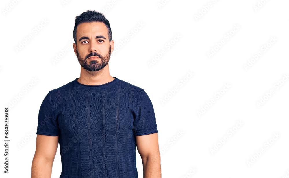 Young hispanic man wearing casual clothes with serious expression on face. simple and natural looking at the camera. Young hispanic man wearing casual clothes with serious expression on face. simple and natural looking at the camera.