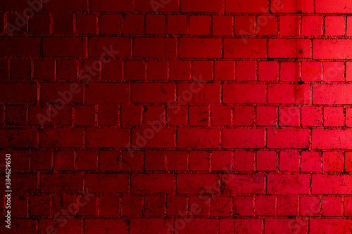 Red brick wall background with shades of light and dark crimson