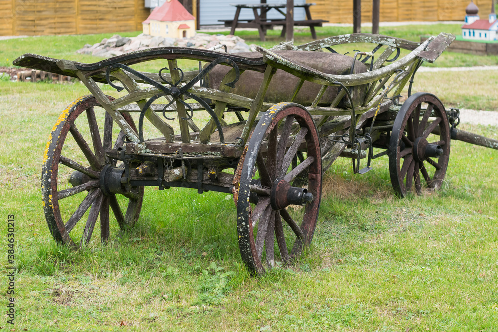 View of an old wooden cart on green grass