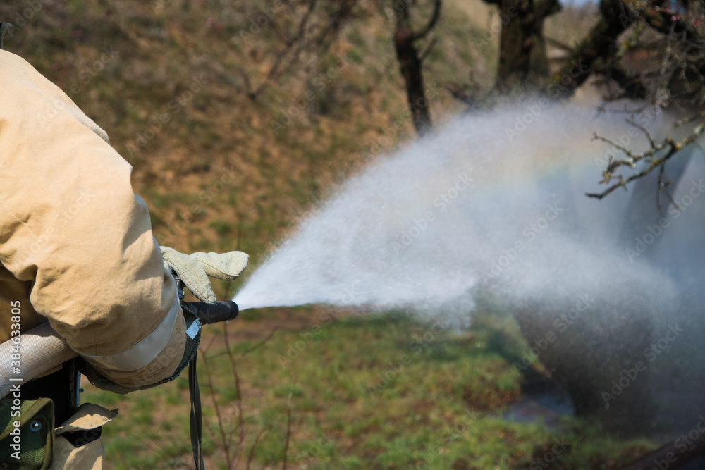Firefighter extinguishes a fire
