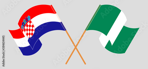 Crossed and waving flags of Nigeria and Croatia