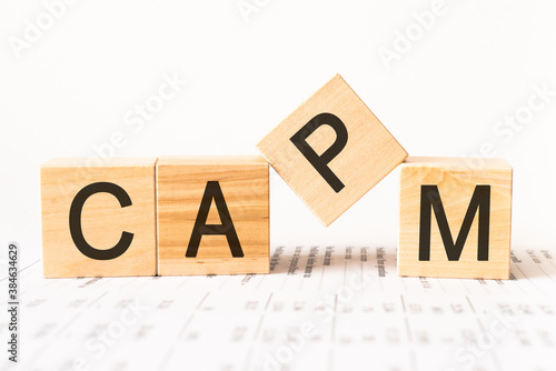 Word capm. Wooden small cubes with letters isolated on white background with copy space available.Business Concept image.