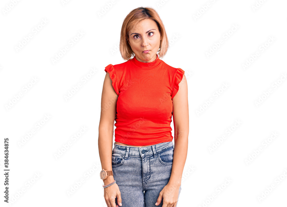 Young blonde woman wearing casual clothes making fish face with lips, crazy and comical gesture. funny expression. Young blonde woman wearing casual clothes making fish face with lips, crazy and comical gesture. funny expression.