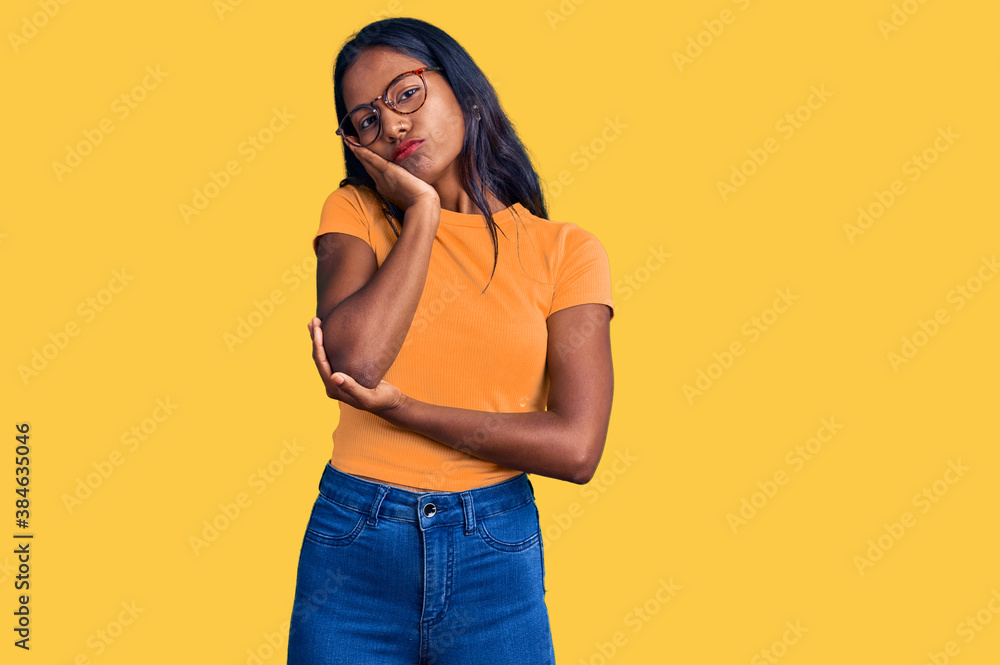 Young indian girl wearing casual clothes and glasses thinking looking tired and bored with depression problems with crossed arms. Young indian girl wearing casual clothes and glasses thinking looking tired and bored with depression problems with crossed arms.