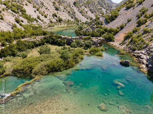 Fototapeta Naklejka Na Ścianę i Meble -  Zrmanja River in northern Dalmatia, Croatia is famous for its crystal clear waters and countless waterfalls surrounded by a deep canyon.