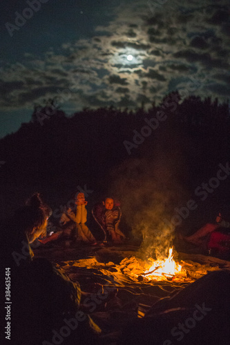campfire with friends under the moon