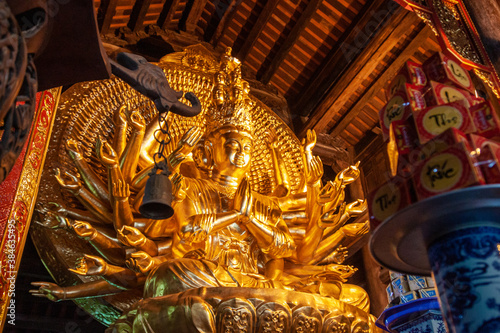 Canvastavla Golden statue of Avalokiteshvara goddess in a buddhist temple, Vietnam