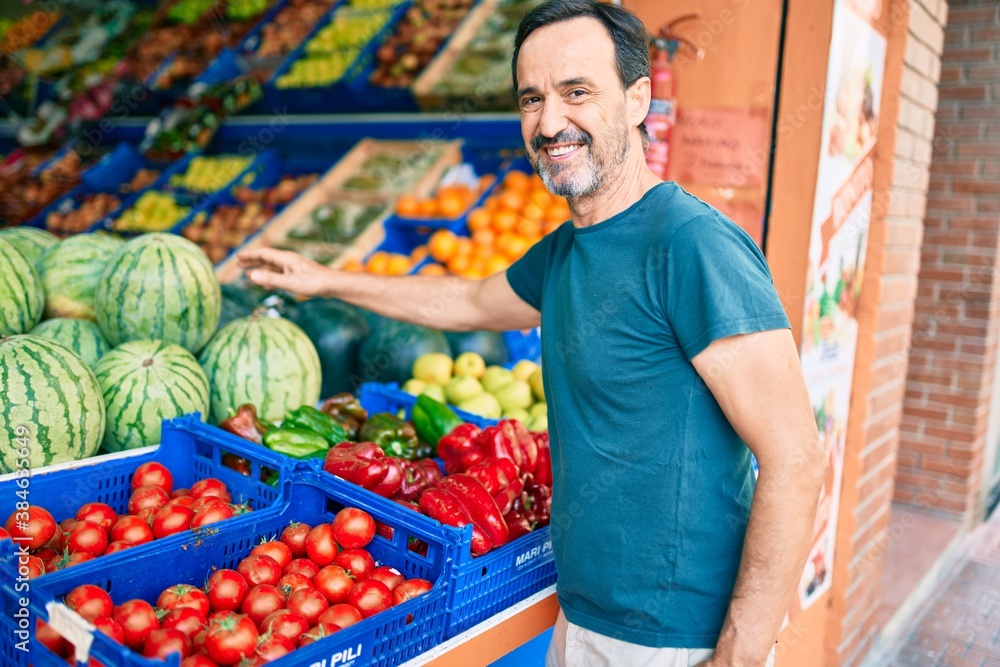 Middle age man with beard smiling happy shopping vegetables at the grocery supermarket Middle age man with beard smiling happy shopping vegetables at the grocery supermarket