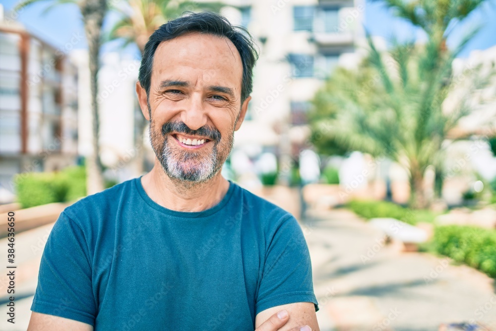 Fototapeta premium Middle age man with beard smiling happy outdoors