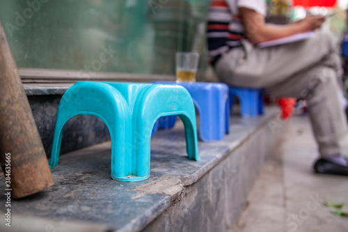 Tiny blue plastic chair stool sidewalk detail, Hanoi, streetlife, Vietnam